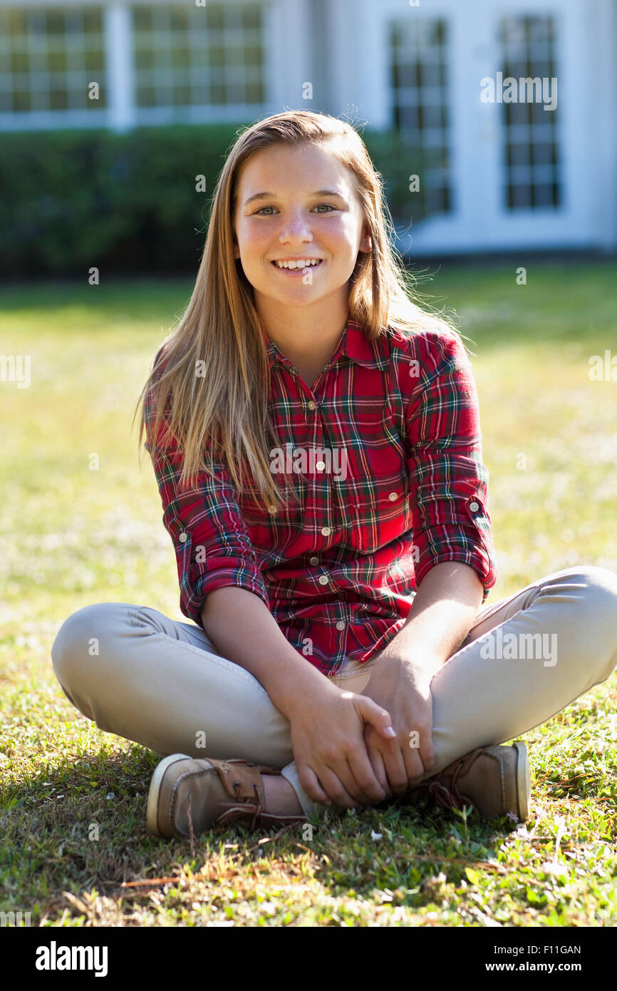 Caucasian girl sitting in backyard Stock Photo - Alamy