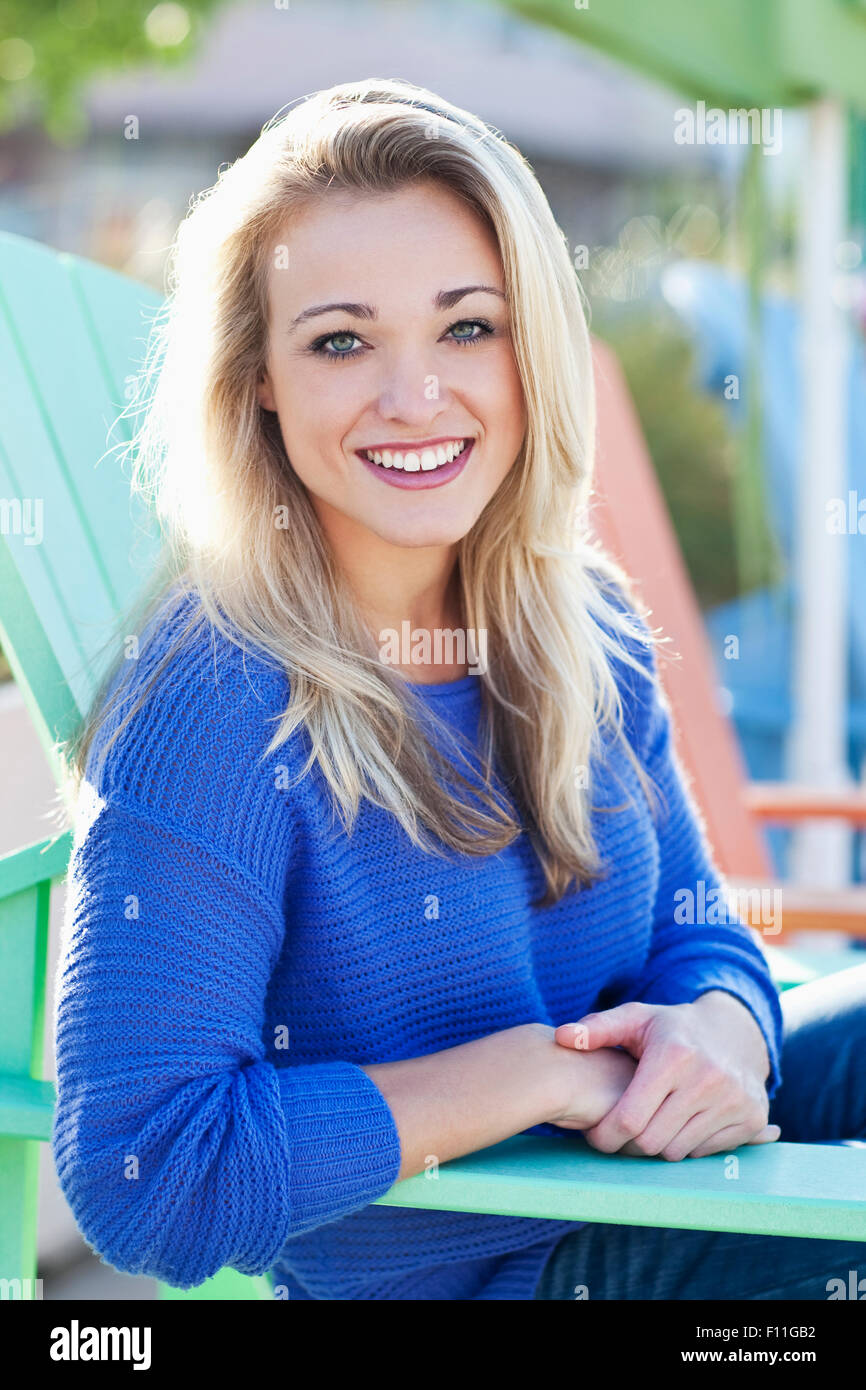 Caucasian woman sitting in deck chair outdoors Stock Photo