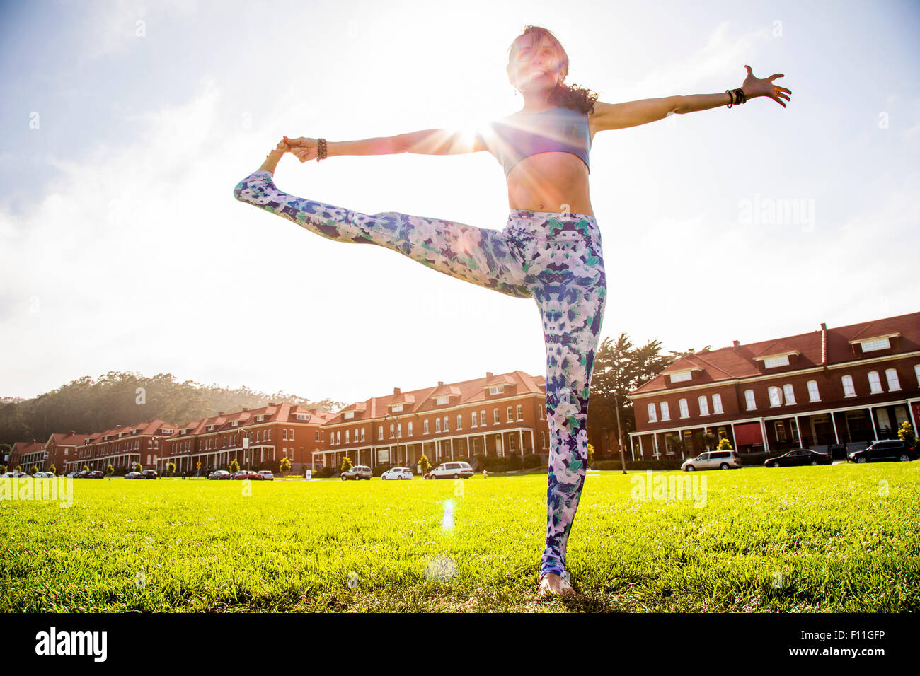 Hispanic woman practicing yoga in urban park Stock Photo