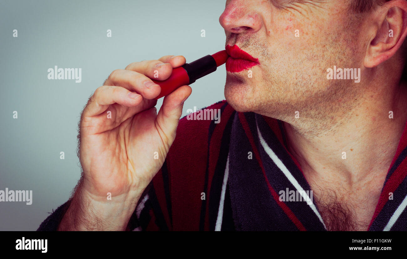 Caucasian man applying lipstick Stock Photo