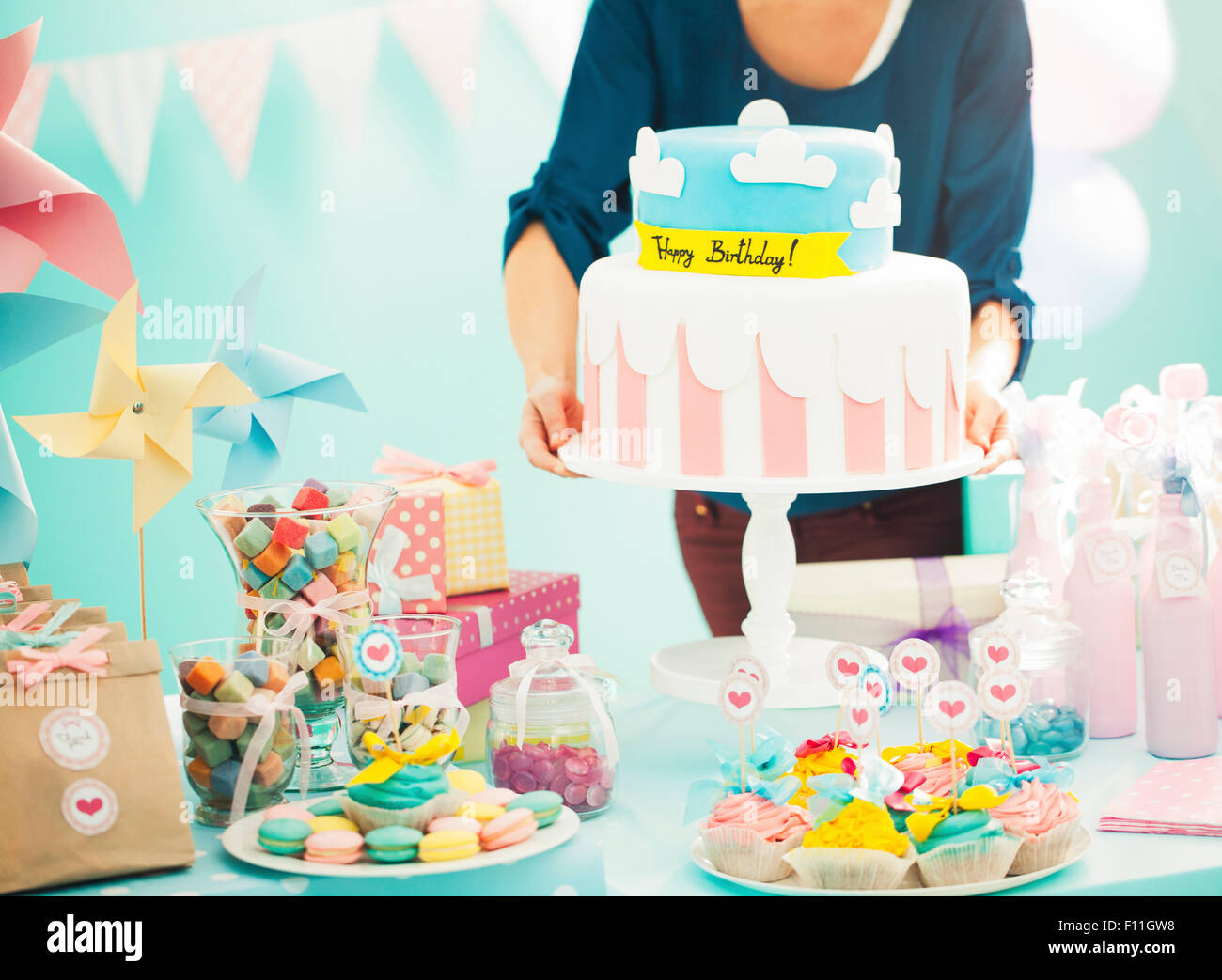 Woman holding birthday cake at party Stock Photo - Alamy
