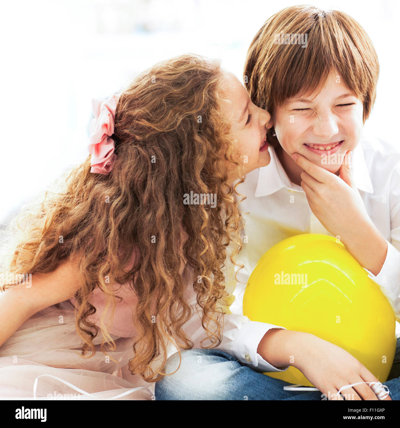 Close up of laughing children whispering Stock Photo