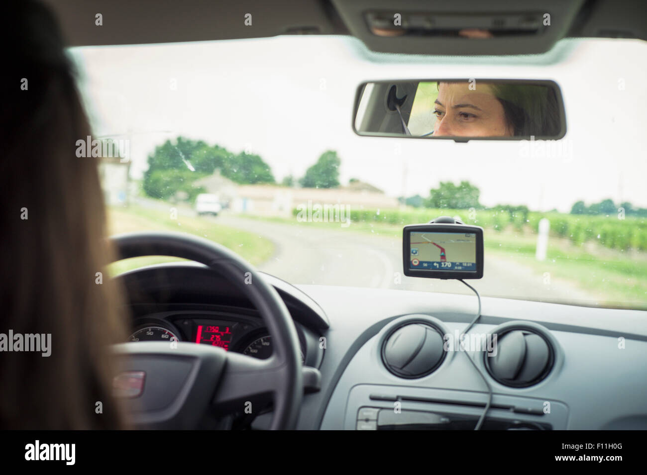 Caucasian woman driving car with GPS navigation Stock Photo