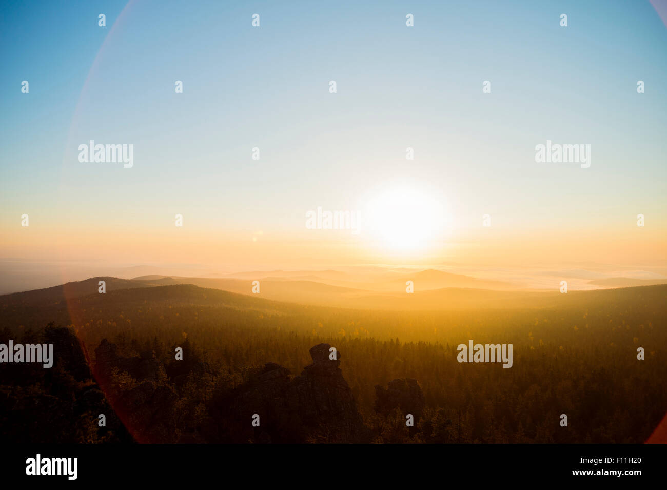 Sunrise over hills in remote landscape Stock Photo