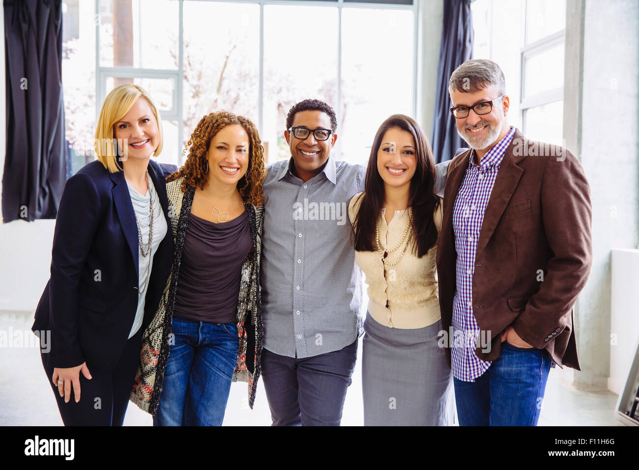 Business people smiling in office Stock Photo