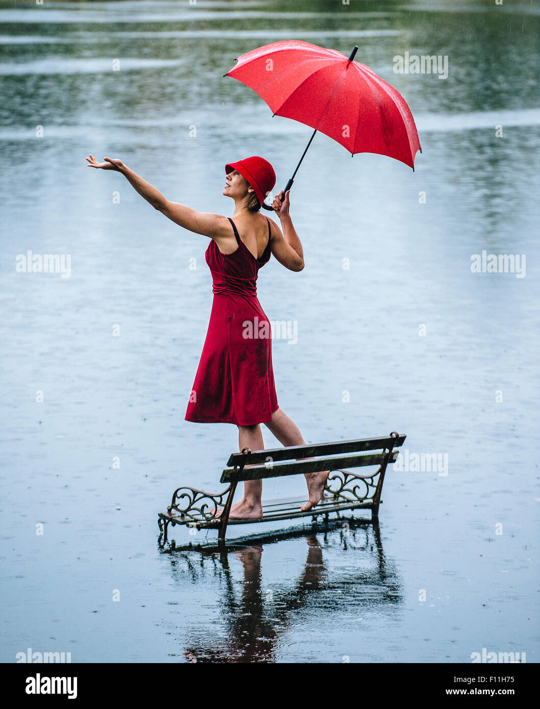 Caucasian woman standing on bench in flood Stock Photo