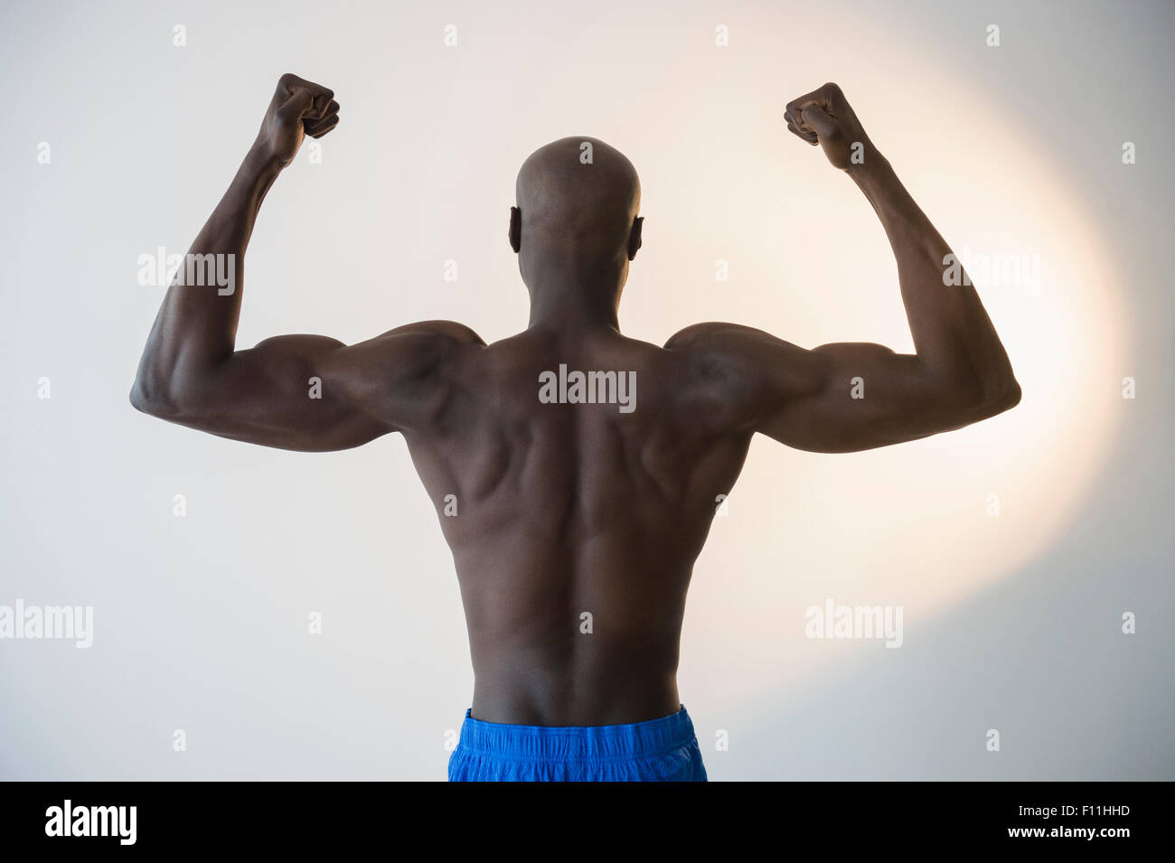 Black man flexing muscles Stock Photo