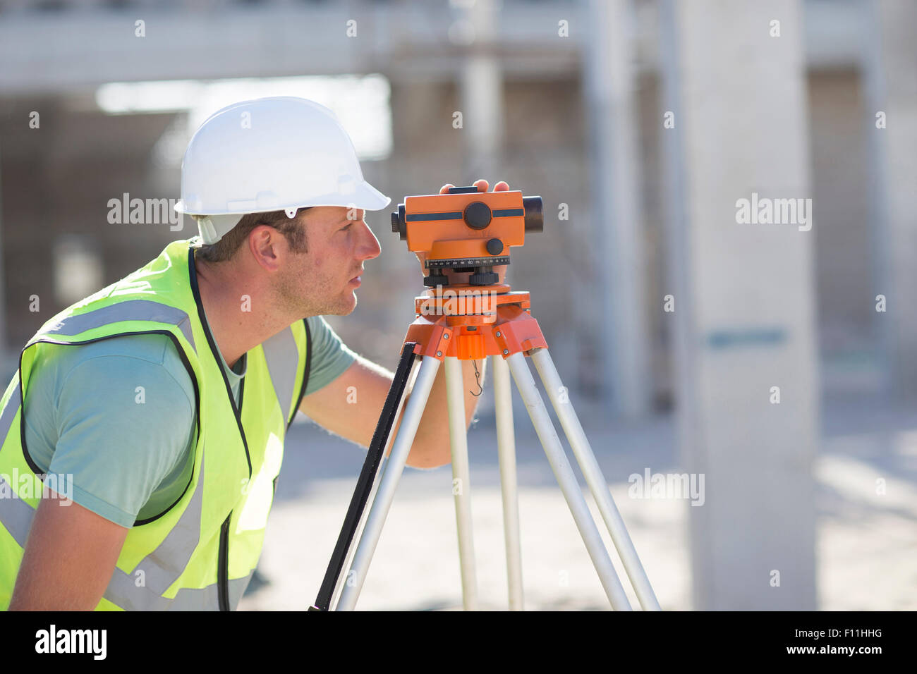 Caucasian surveyor examining construction site Stock Photo