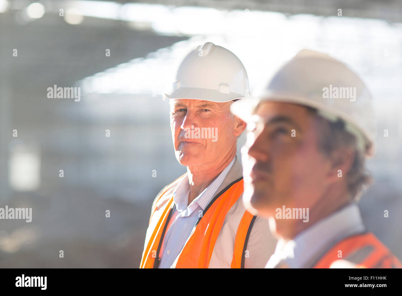Caucasian architects standing at construction site Stock Photo