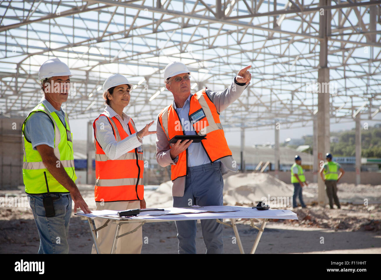 Architects talking at construction site Stock Photo