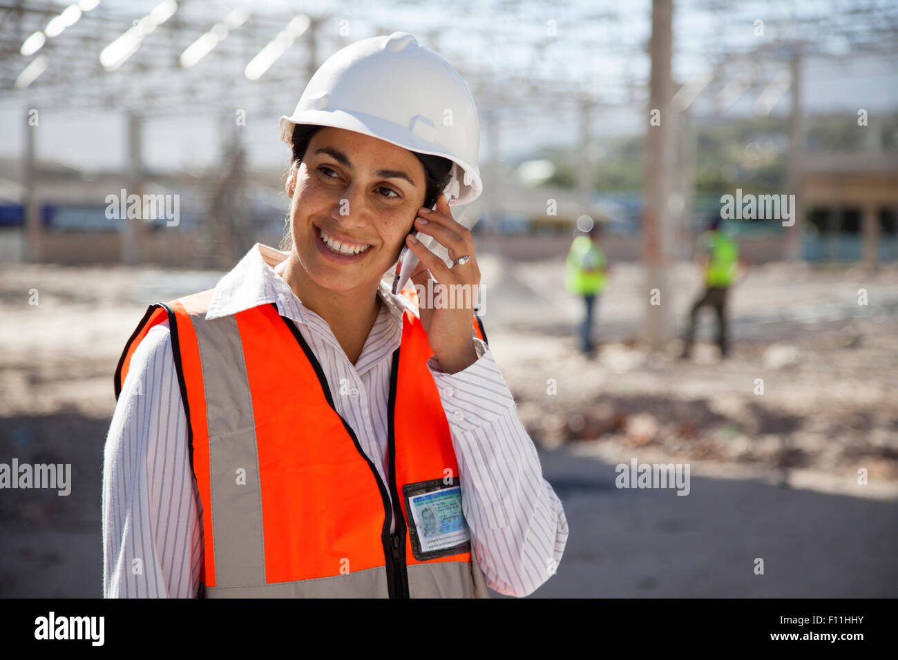 Architect talking on cell phone at construction site Stock Photo