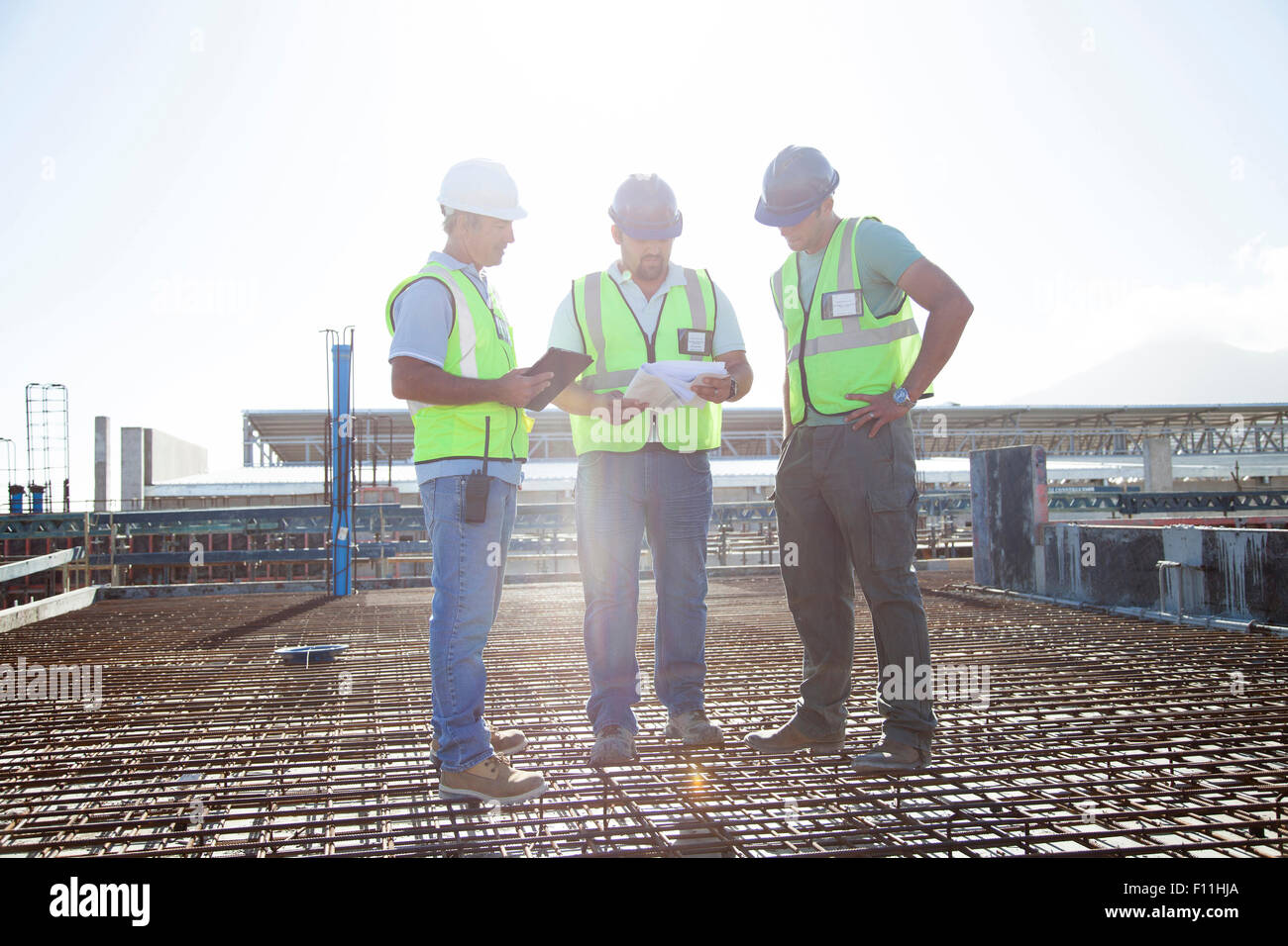 Construction workers talking on rebar at construction site Stock Photo