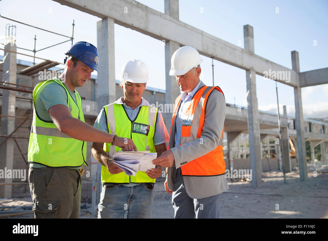 Architects talking at construction site Stock Photo