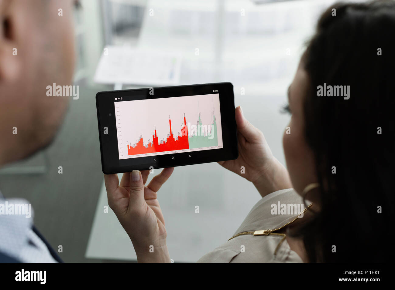 Business people viewing graph on digital tablet Stock Photo