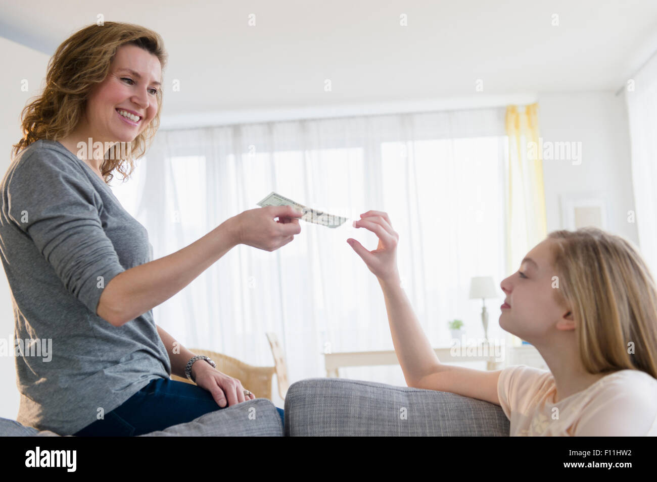 Mom Gives Pocket Money To Her Son Stock Image - Image of accept