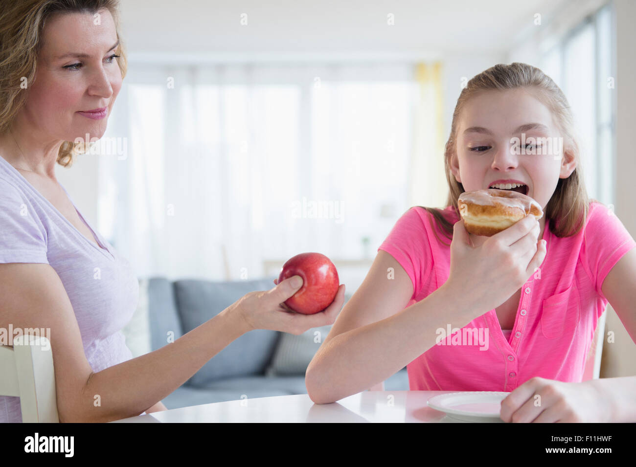 Caucasian mother offering daughter healthy food Stock Photo