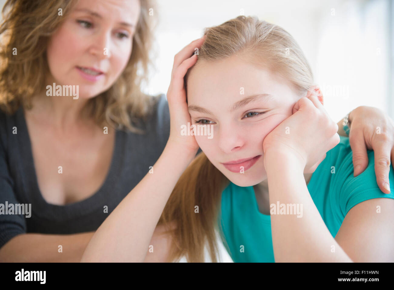 Caucasian mother comforting crying daughter Stock Photo