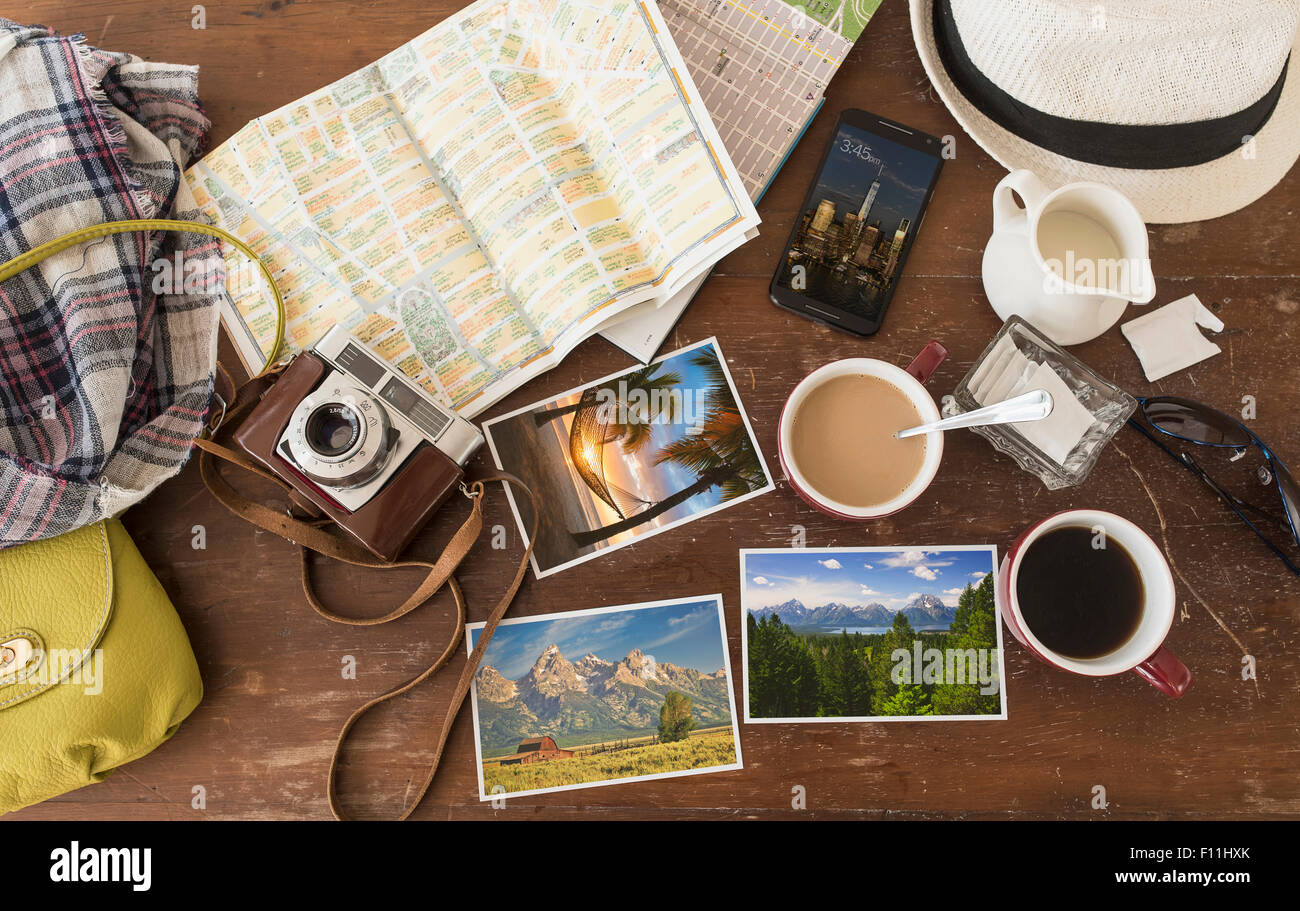 High angle view of coffee, maps, photographs, camera and cell phone Stock Photo