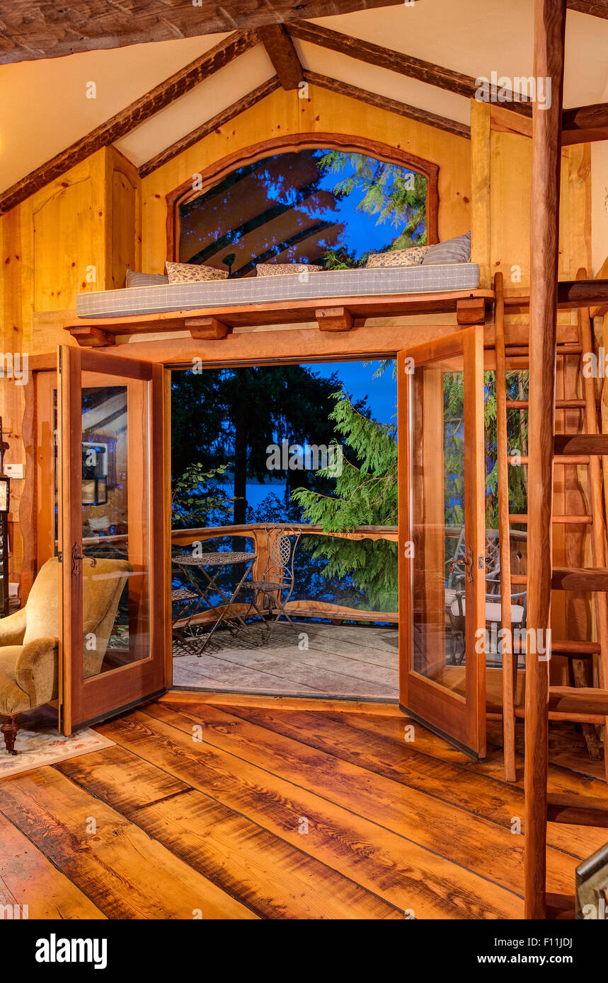 Doorway and loft of wooden tree house Stock Photo