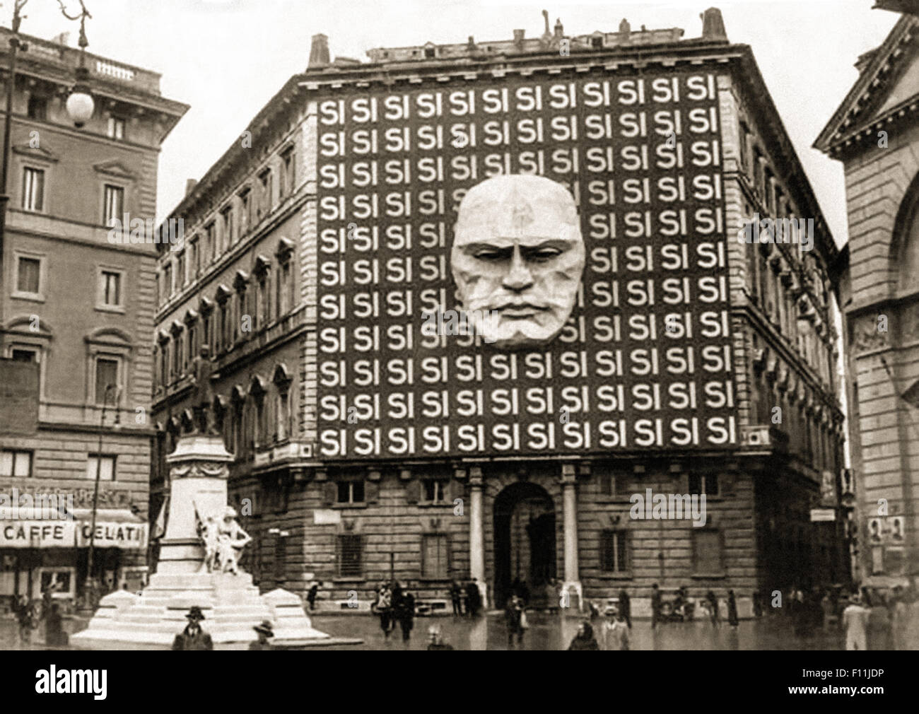 Partito Nazionale Fascista (PNF), National Fascist Party headquarters at the Palazzo Braschi, Rome, Rome in 1934 decorated with the giant face of Benito Mussolini (1883-1945) and the word 'Si' meaning 'Yes' is in reference to the Italian general election which took place on 26 March 1934 in the form of a referendum; voters could either approve or reject the Grand Council of the National Fascist Party, 99.84% of voters voted 'si'. The party ruled Italy from 1922 when Fascists took the power with the March on Rome, to 1943, when Mussolini was deposed by the Grand Council of Fascism itself. Stock Photo