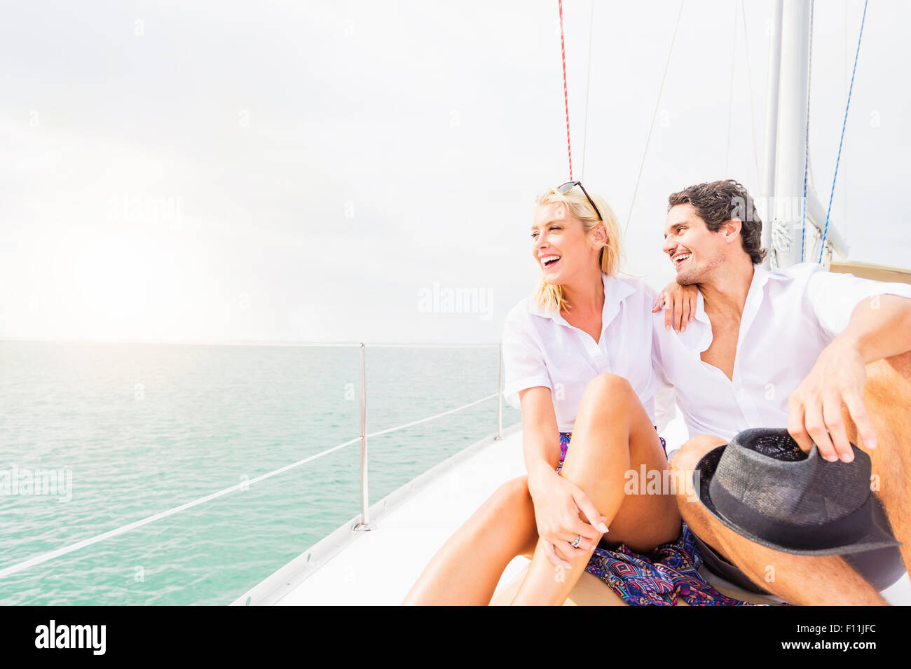 Couple hugging on deck of sailboat Stock Photo - Alamy