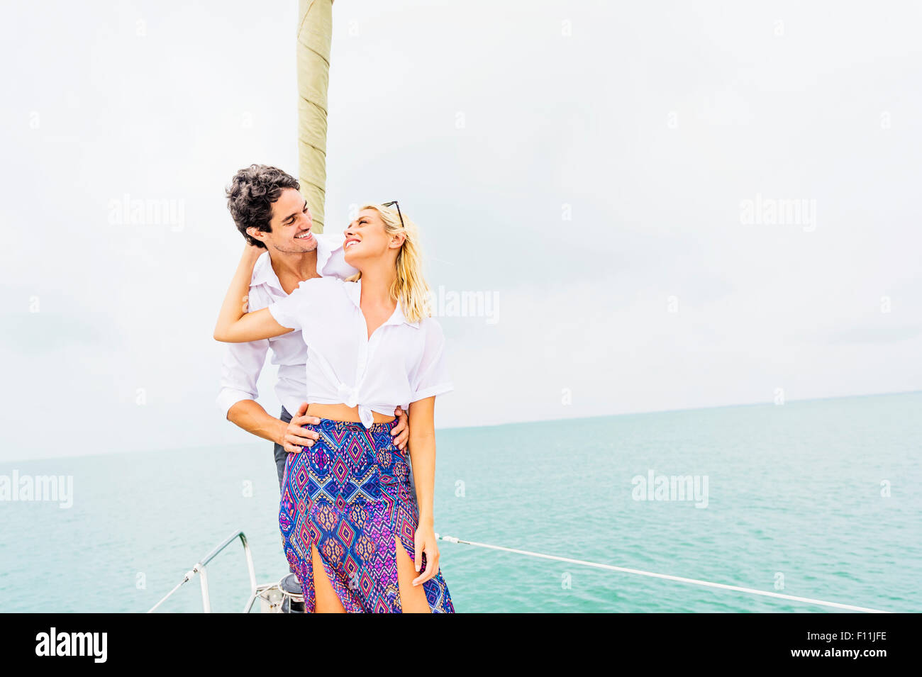 Couple hugging on deck of sailboat Stock Photo - Alamy