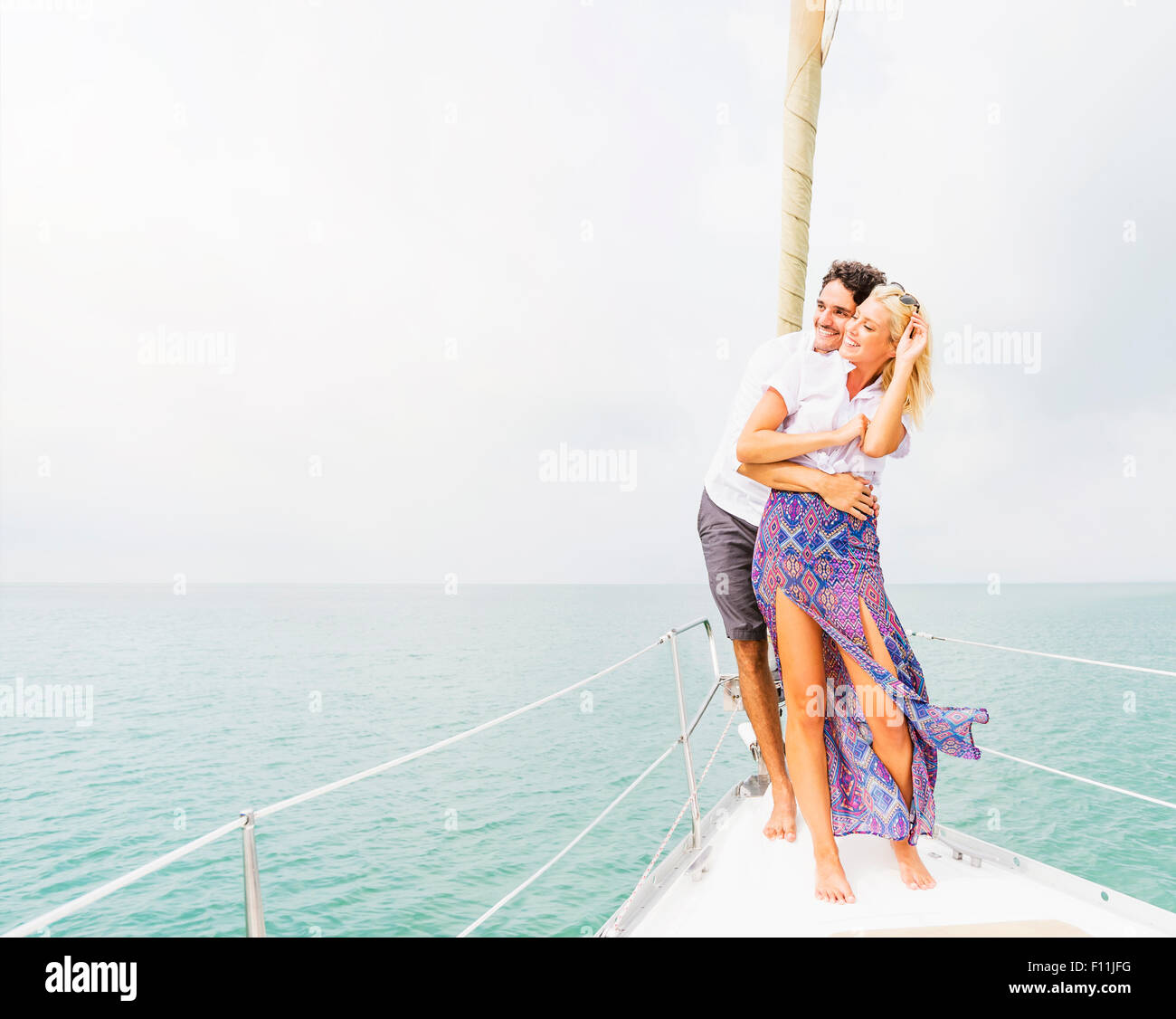 Couple hugging on deck of sailboat Stock Photo - Alamy