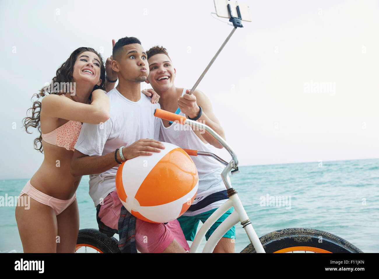 Smiling friends taking selfie on beach Stock Photo