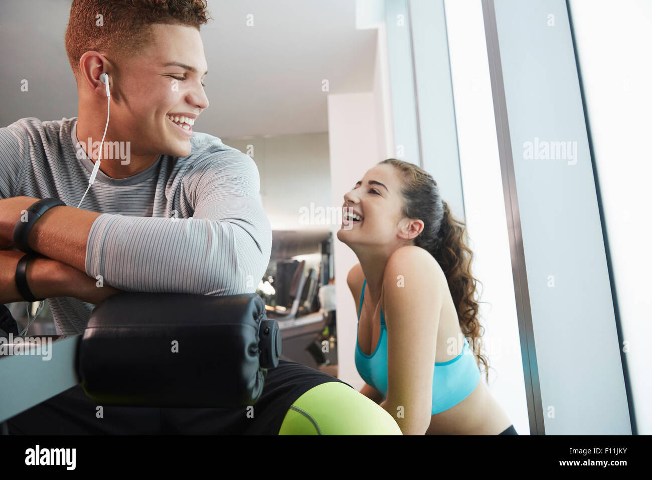 Smiling couple laughing in gym Stock Photo