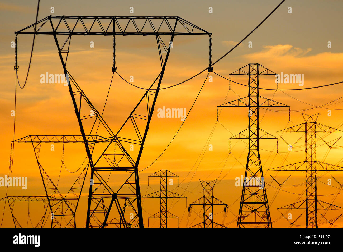 Silhouette of power lines under sunset sky Stock Photo