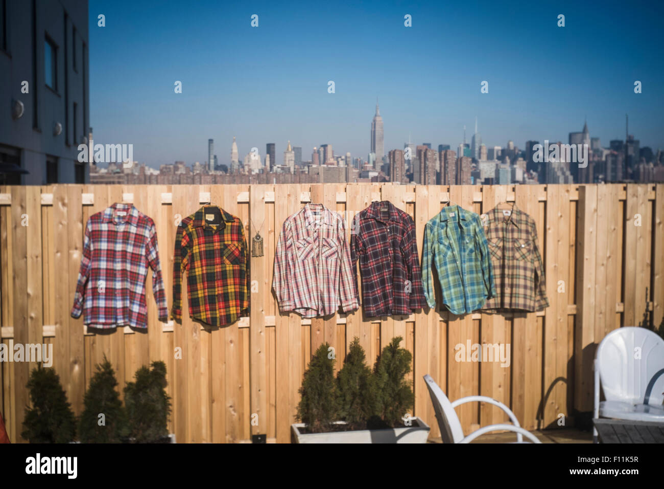 Flannel shirts hanging to dry in urban backyard, New York, New York, United States Stock Photo