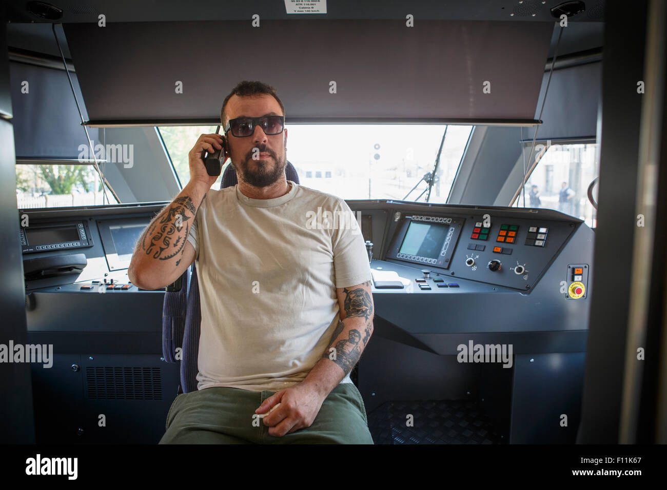 Caucasian man talking on cell phone in command center Stock Photo