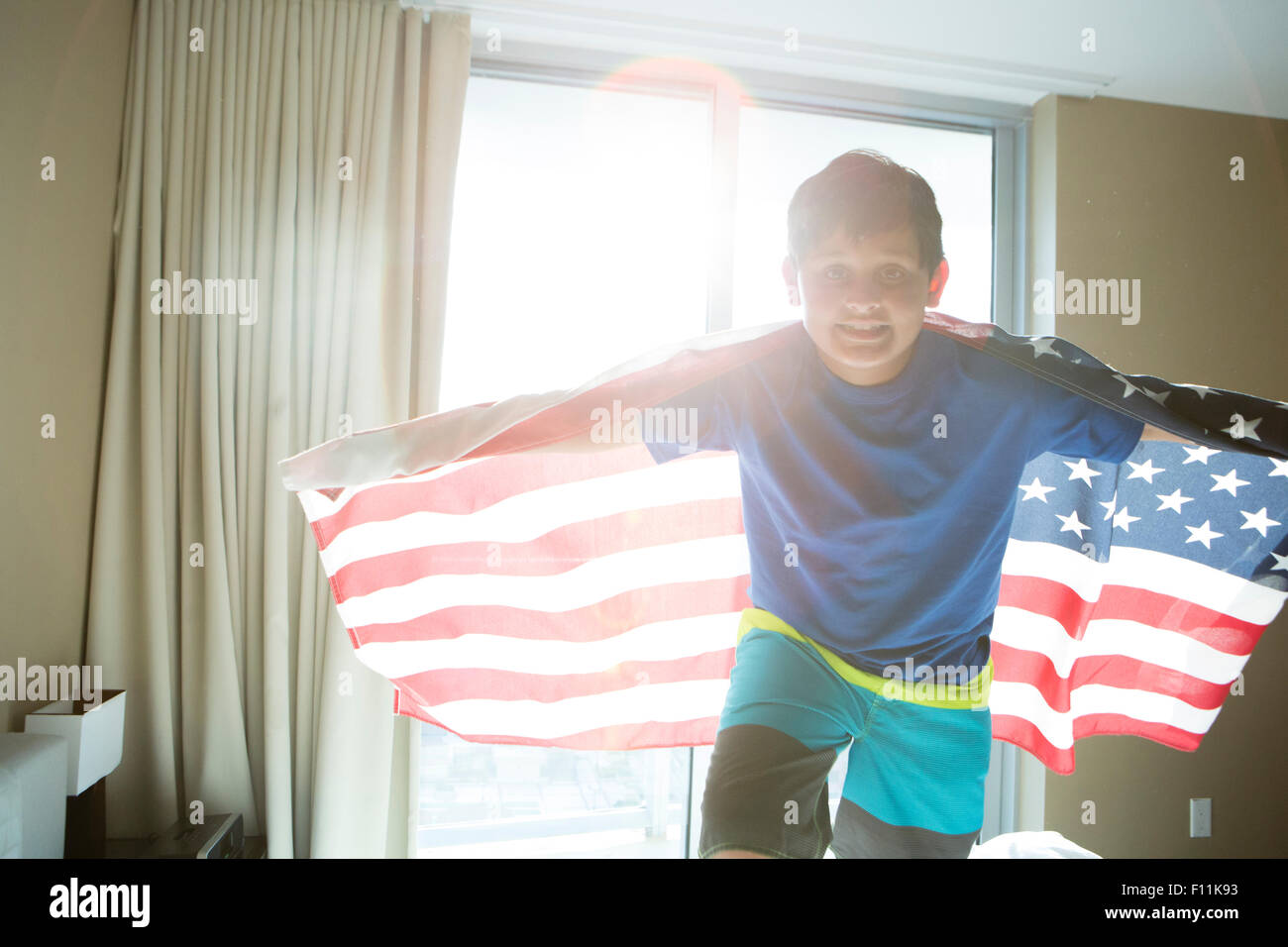 Hispanic boy using American flag as cape Stock Photo