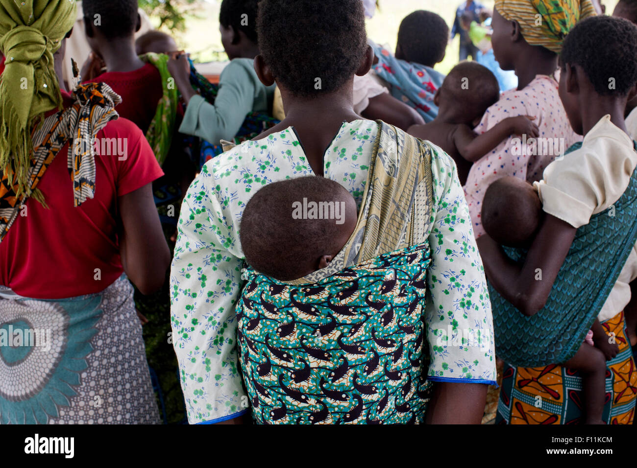 Mothers carrying children and waiting at rural health clinic Stock Photo