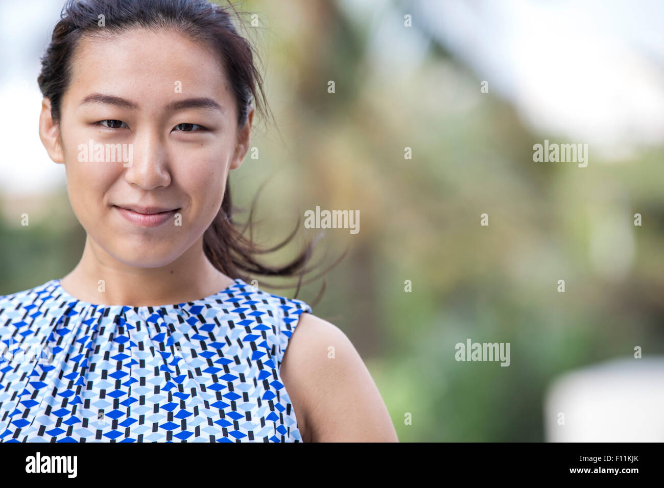 Close up of Asian businesswoman smiling outdoors Stock Photo