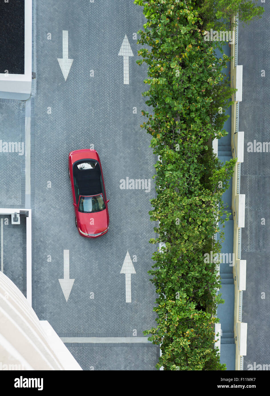 Aerial view of car driving on street with arrows Stock Photo