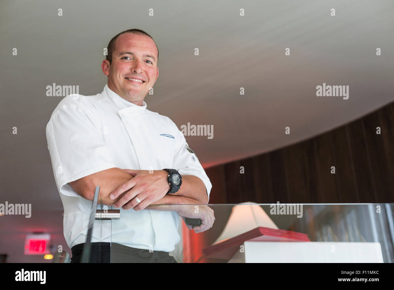 Low angle view of chef standing in dining room Stock Photo