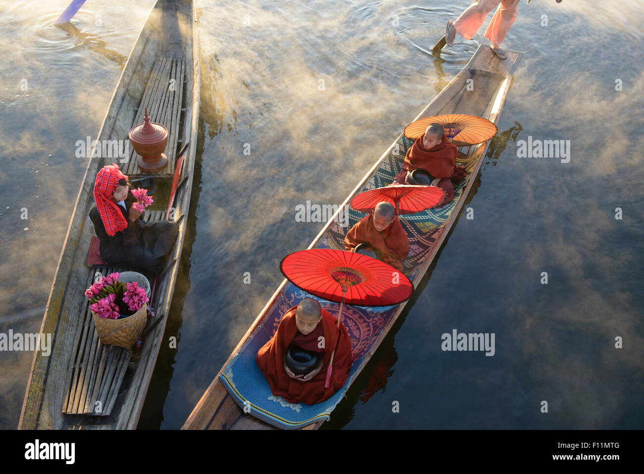 Asian gondoliers rowing canoes on river Stock Photo