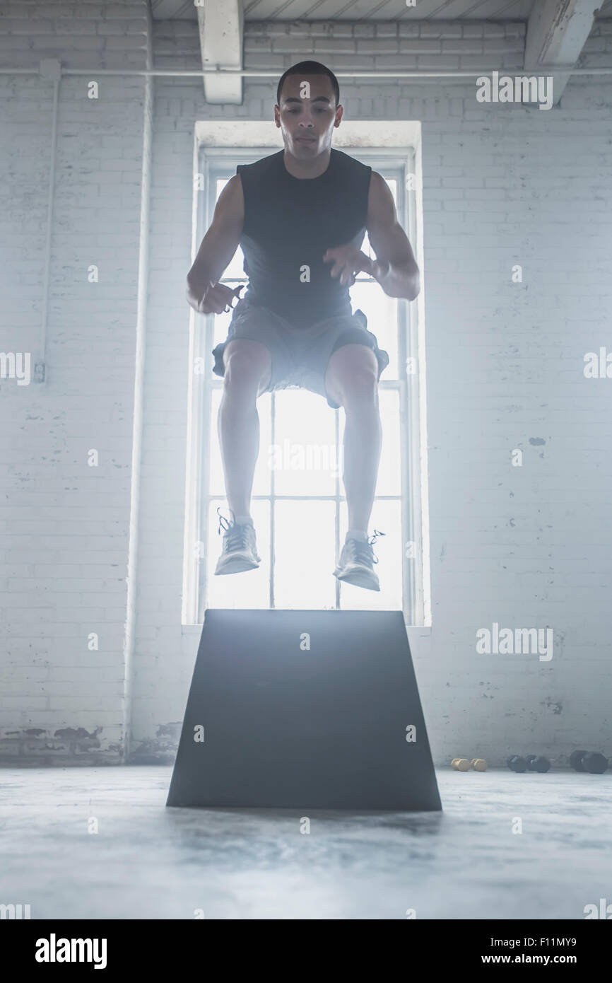 Athlete jumping on platform Stock Photo