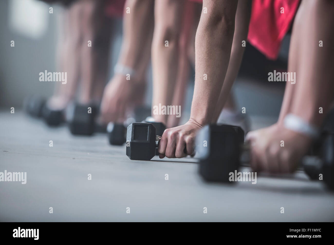 Athletes doing pushups and lifting weights on floor Stock Photo Alamy