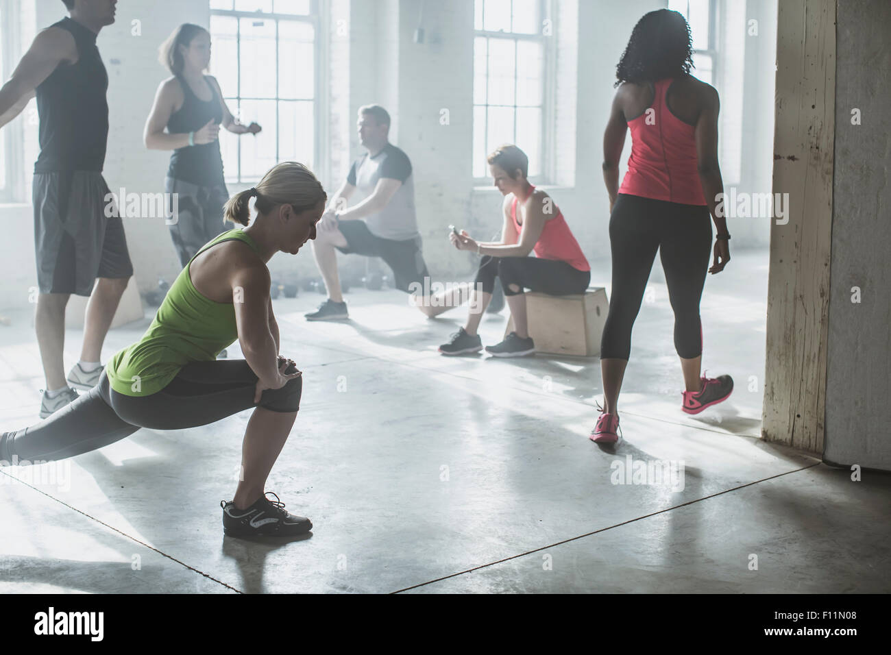 Athletes stretching in gym Stock Photo