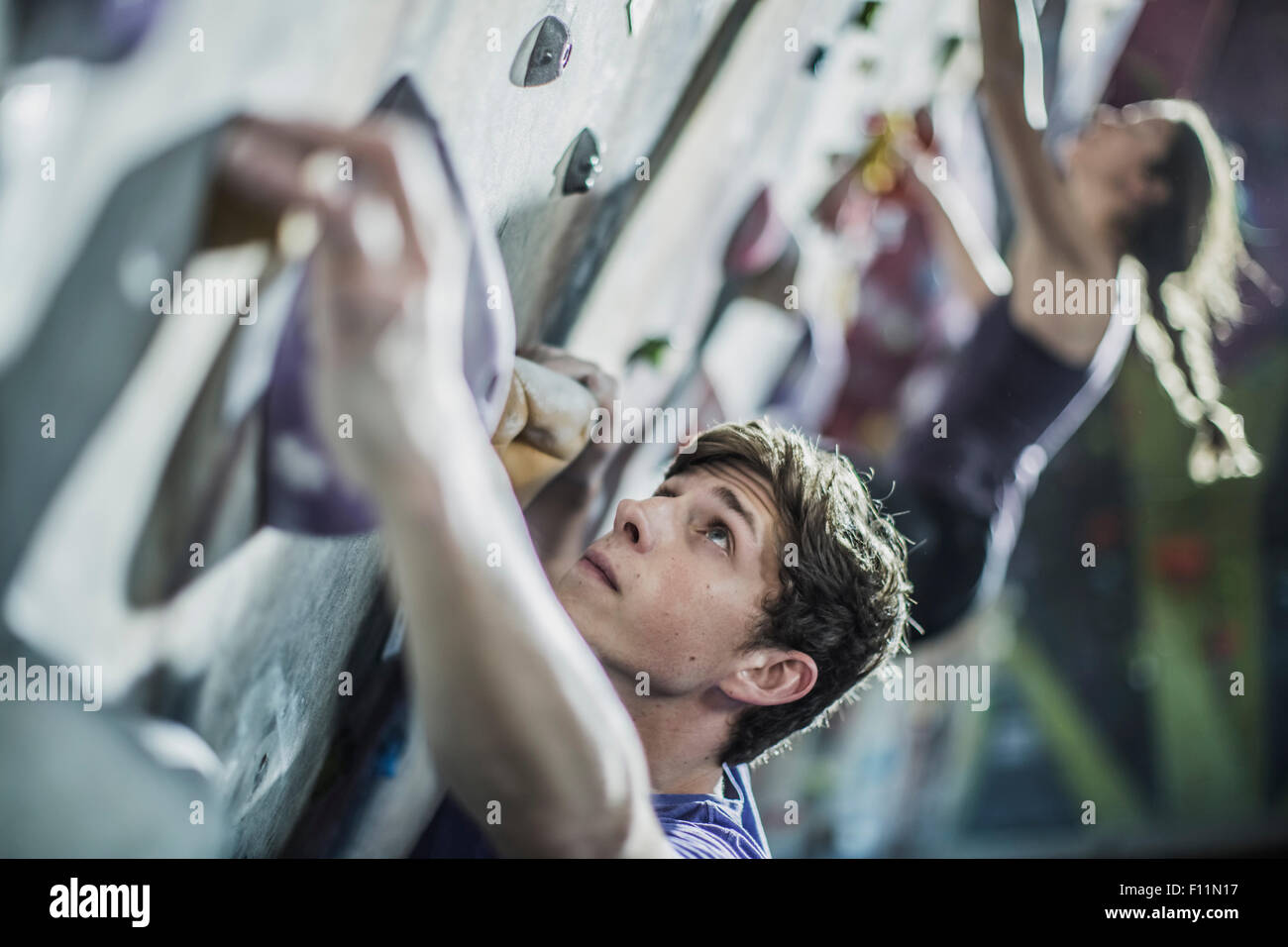 Man scaling climbing wall hi-res stock photography and images - Alamy