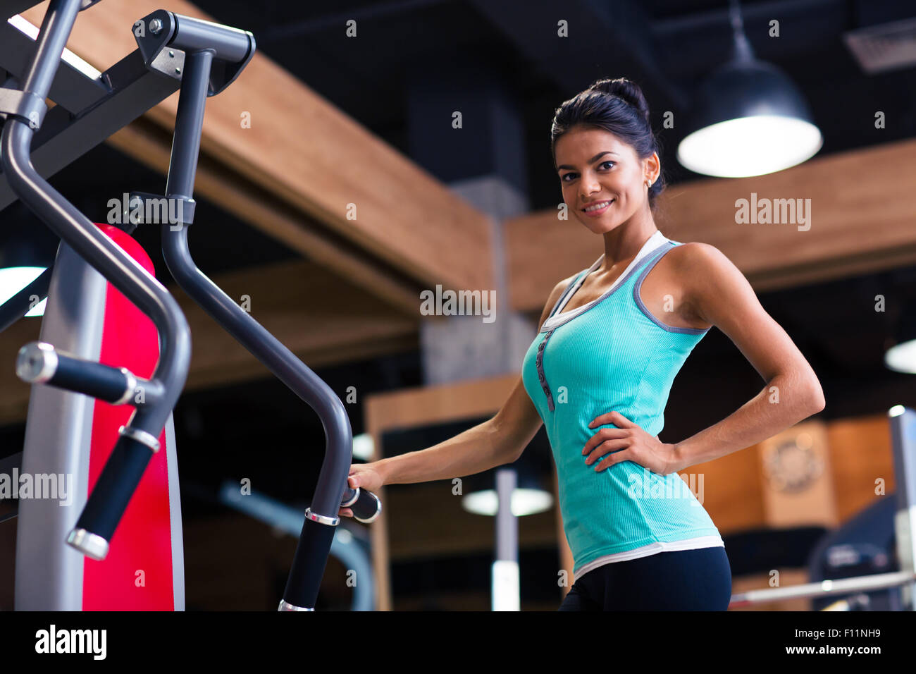 Portrait of a happy cute woman standing in fitness gym Stock Photo - Alamy
