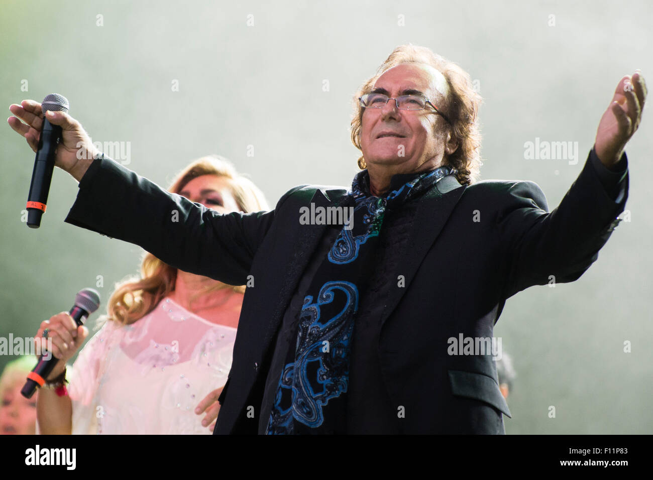Berlin, Germany. 21st Aug, 2015. Singing duo Romina Power (L) and Albano Carrisi (Al Bano) perform on stage during a concert in Berlin, Germany, 21 August 2015. The concert was their first in the German-speaking region in 20 years. Photo: Gregor Fischer/dpa/Alamy Live News Stock Photo