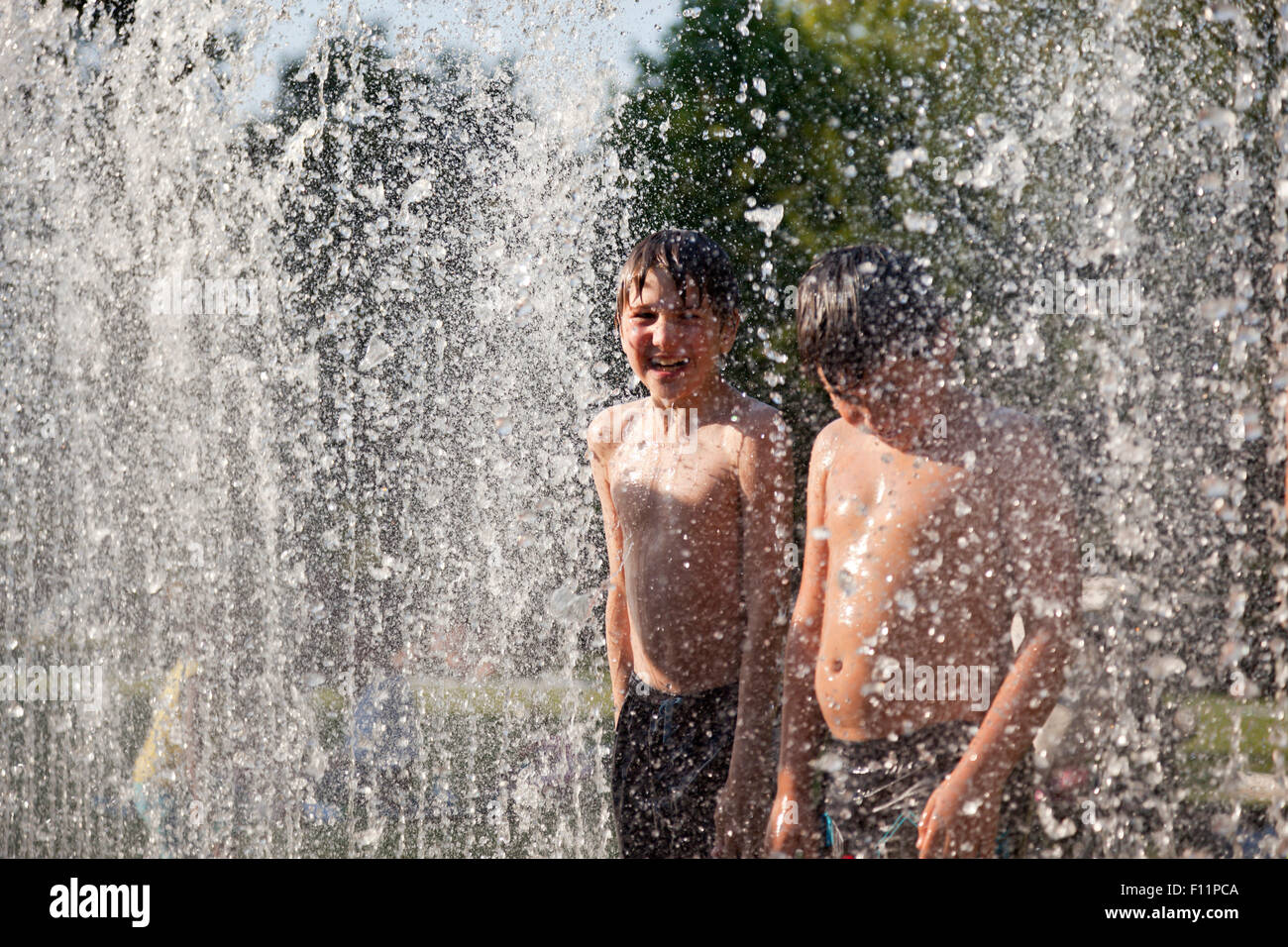 kids bathing in the Jeppe Hein fountain, Kiel, Schleswig-Holstein, Germany Stock Photo