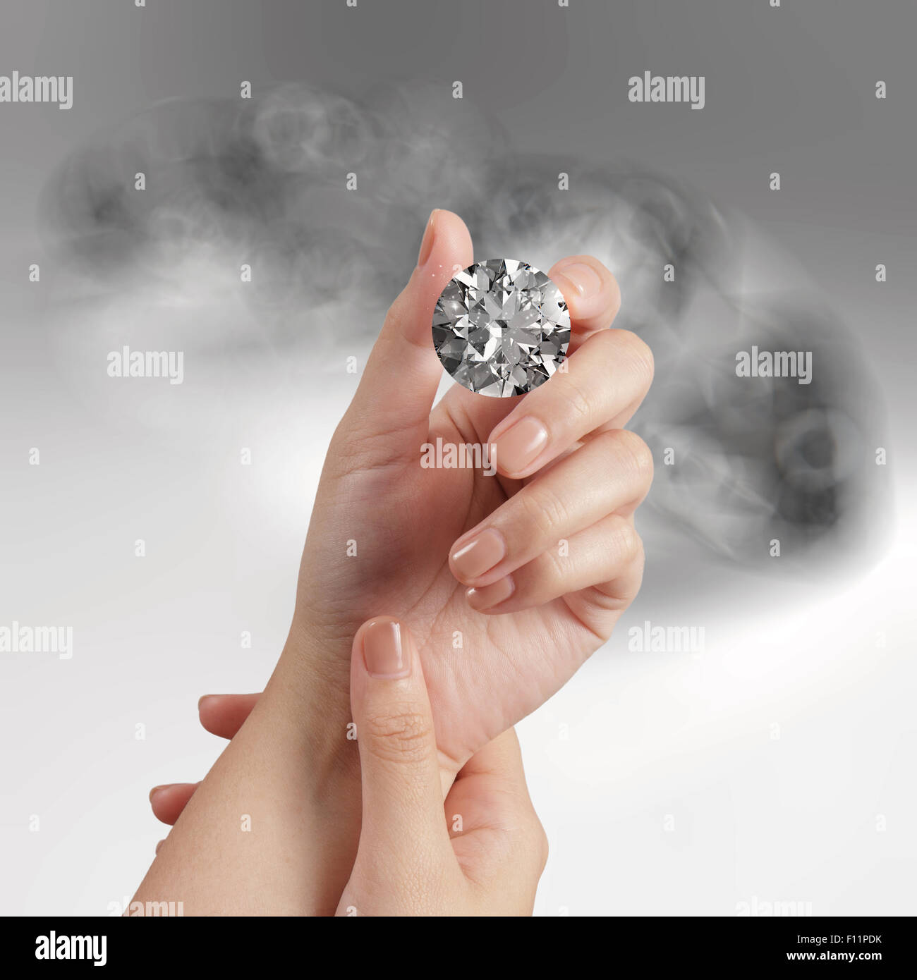 hand holding 3d diamond over grey background Stock Photo