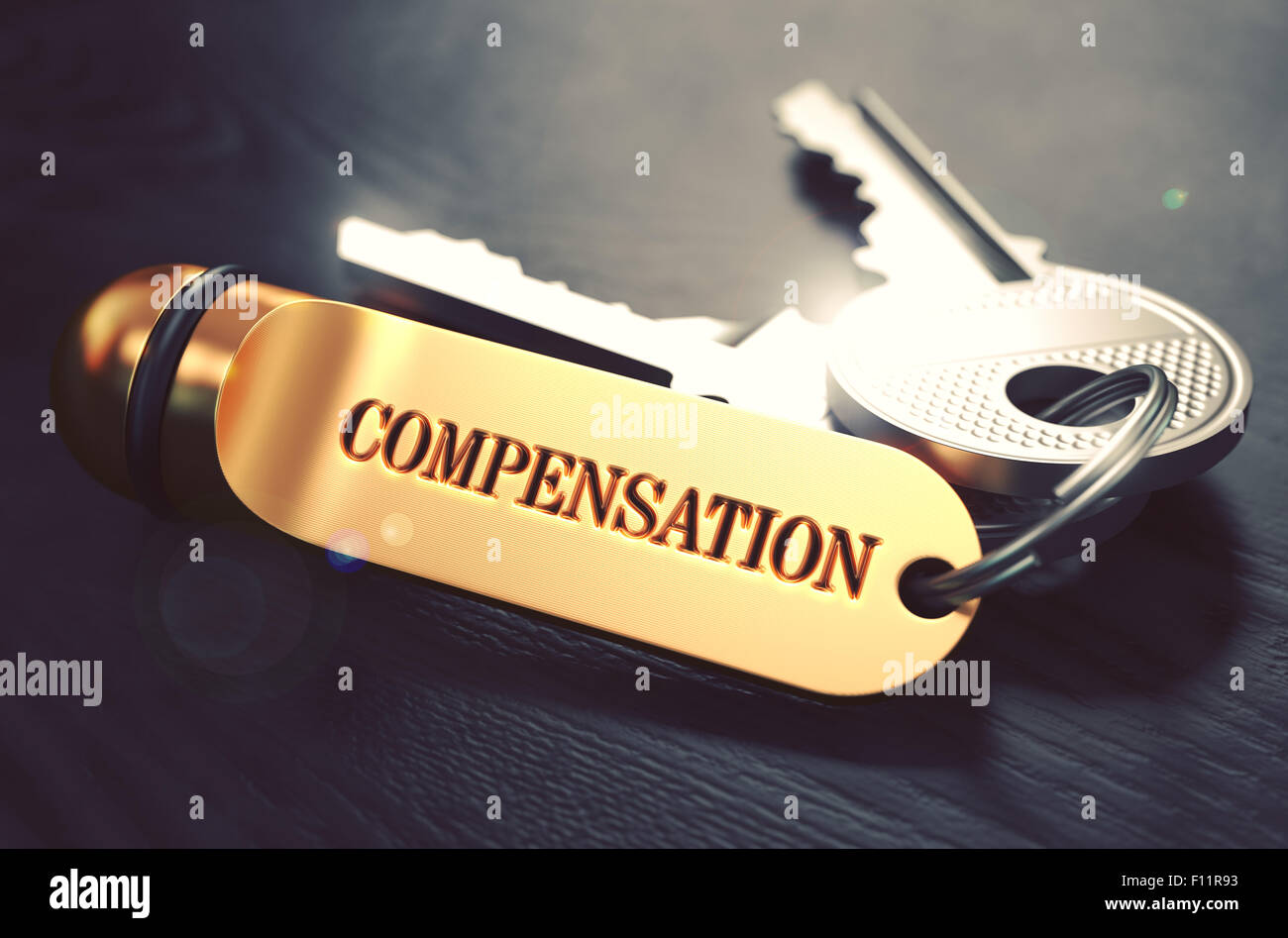 Keys with Word Compensation on Golden Label. Stock Photo