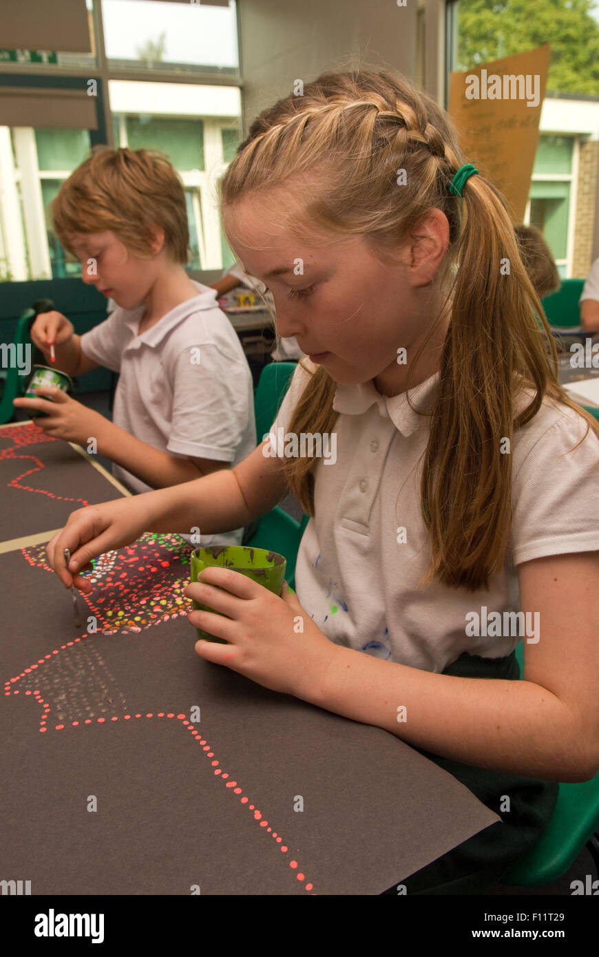 Primary school pupil's at work in art in the classroom, Midlands, UK. Stock Photo