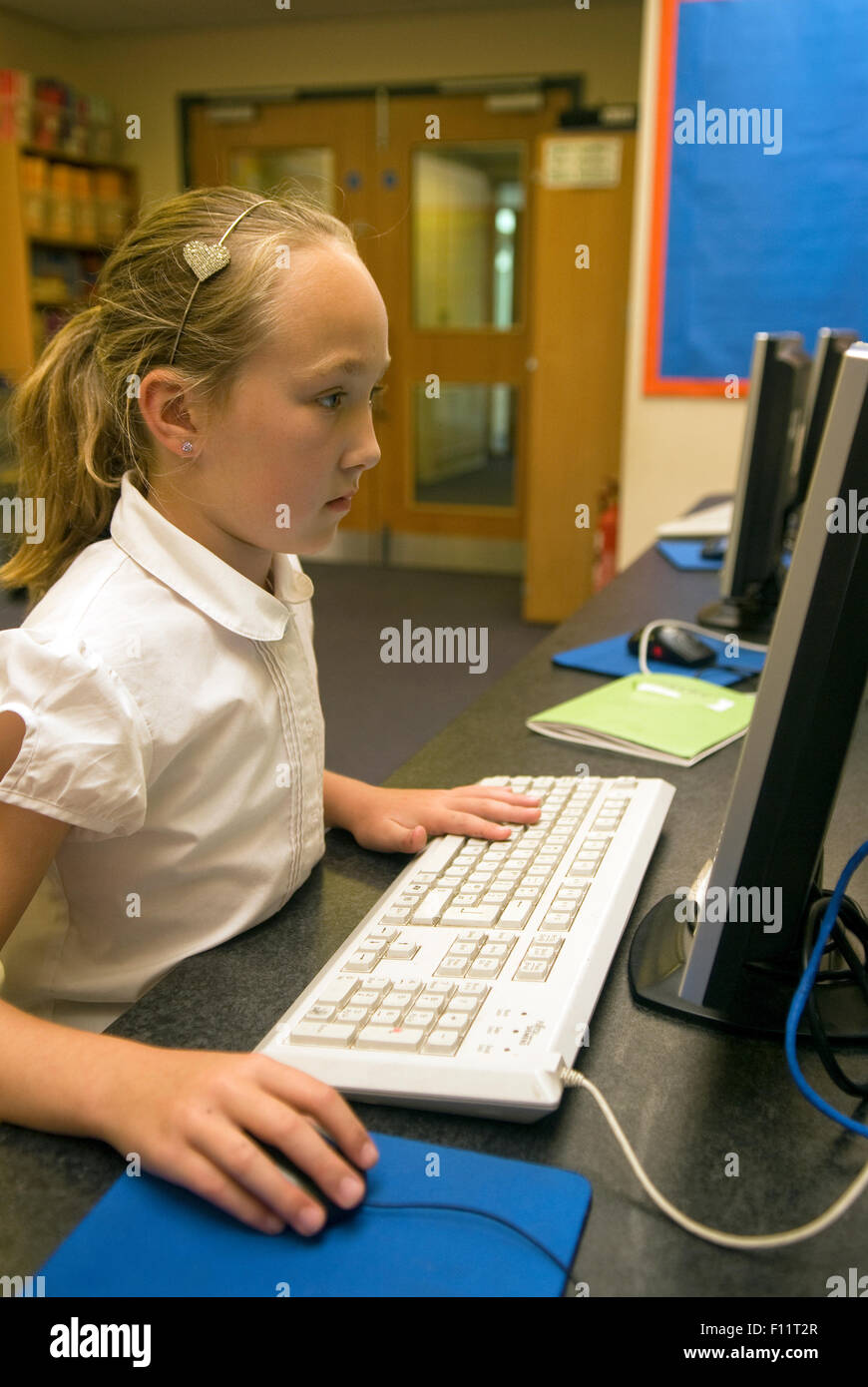 Primary school pupil using computer in school, Midlands, UK. Stock Photo
