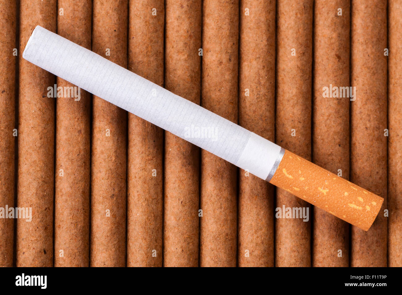Cigarette with brown filter on dark cigarettes close up Stock Photo